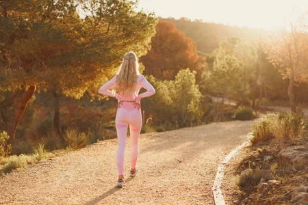 Jogger in Sunlit Forest