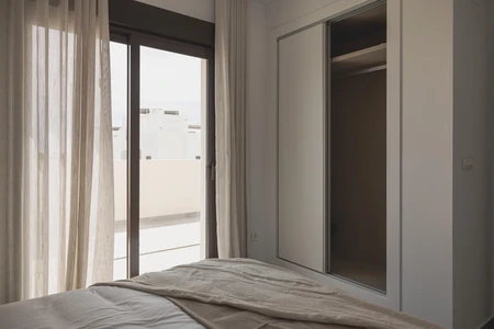 Minimalist Bedroom with Balcony View