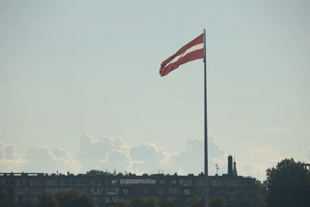 Latvian Flag Against Skyline