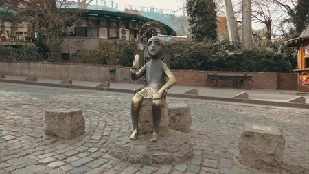 Statue on a Cobblestone Street