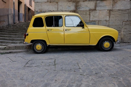 Vintage Yellow Car on Cobblestone