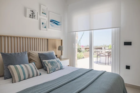 Cozy Bedroom with Balcony View