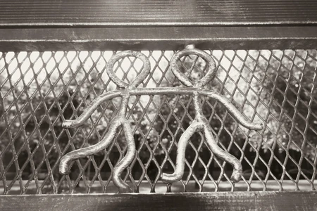 Metal Figures on a Fence