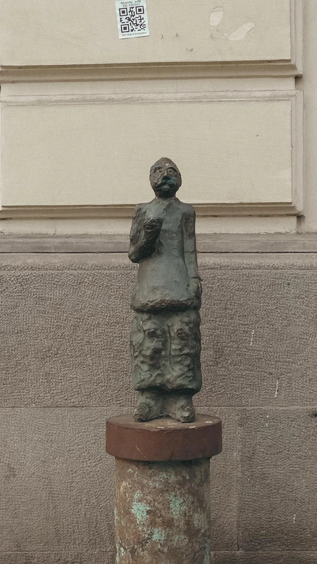 Bronze Sculpture Against Building