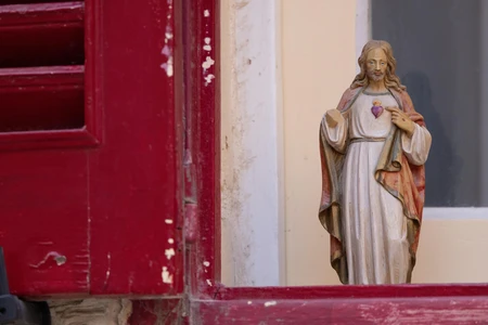 Statue by Red Window