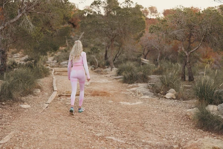 Woman Walking Through Nature Trail