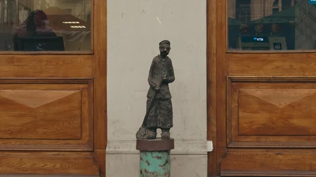 Statue by Wooden Doors