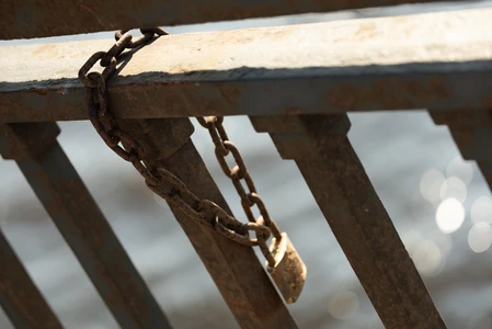 Weathered Lock on Metal Rail