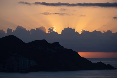 Sunset Over Silhouetted Hills