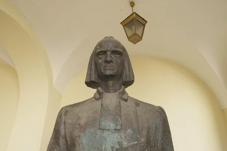 Bronze Statue Under Archway