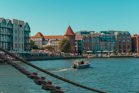 Riverside Cityscape with Boat
