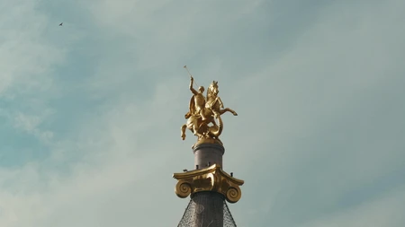 Golden Statue on Pedestal