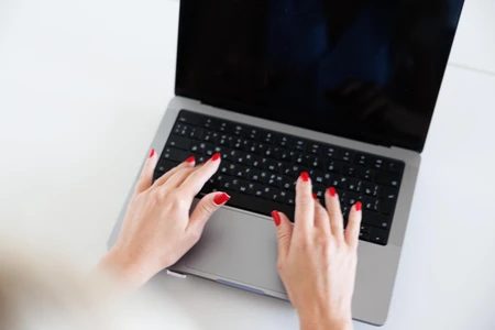 Hands Typing on Laptop