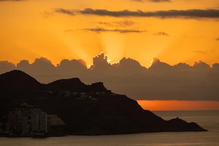 Sunset Over Mountainous Coastline