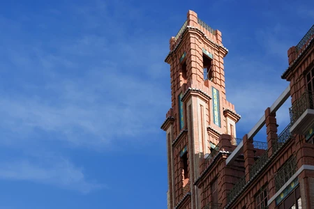 Architectural Brick Tower Against Blue Sky