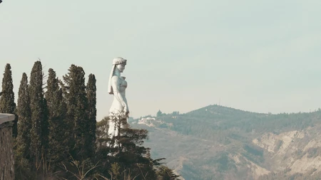 Statue Overlooking Scenic Landscape