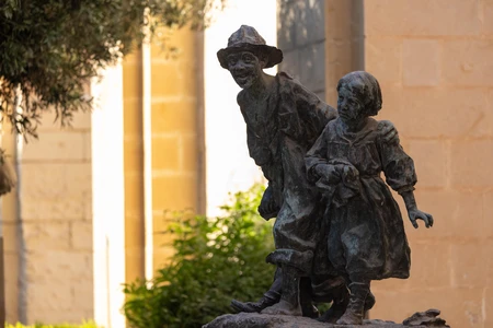 Charming Bronze Statue in Sunlit Setting