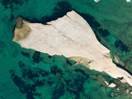 Aerial View of Rock Formation in Crystal Clear Waters