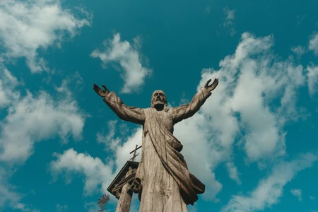 Statue with Open Arms Under Sky