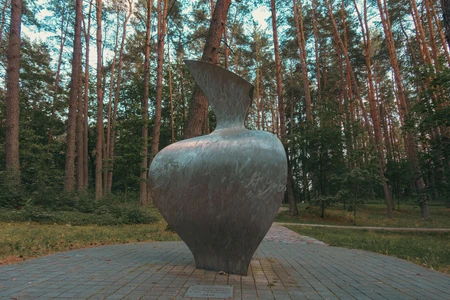 Metallic Sculpture in Forested Park