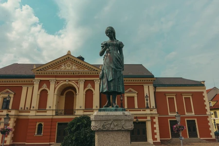 Historic Statue in Front of Classical Building