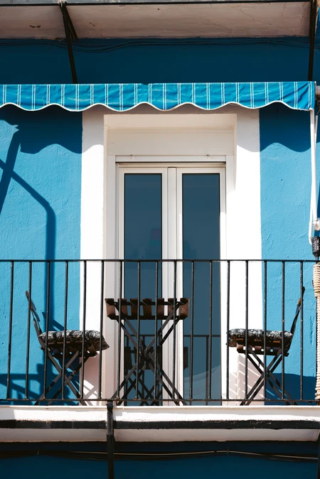 Charming Balcony with Blue Facade