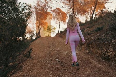 Woman Walking in Autumnal Path