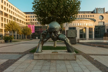 Contemplative Sculpture in Urban Plaza