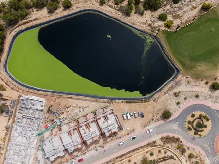 Aerial View of Construction Site and Pond
