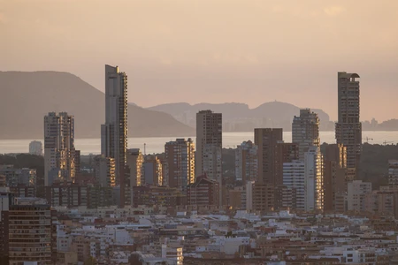 Sunset Cityscape with Mountains