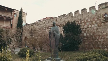 Historical Statue and Ancient Wall