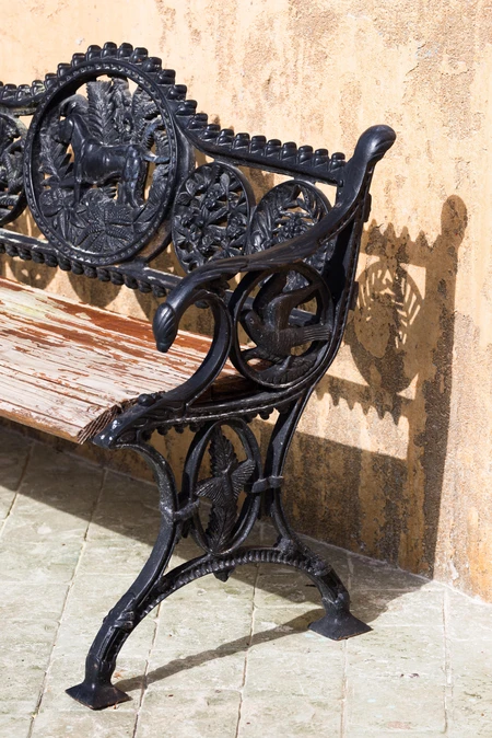 Ornate Iron Bench in Sunlight