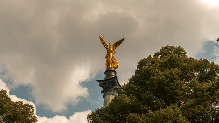 Golden Statue against Cloudy Sky