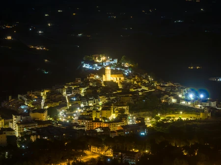 Illuminated Hilltop Town at Night