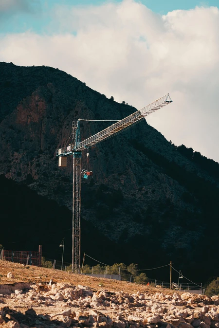 Construction Crane in Mountain Landscape
