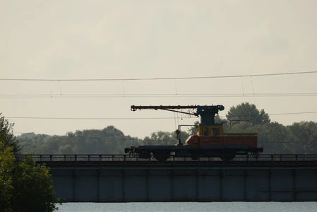 Silhouette of a Construction Train on a Bridge