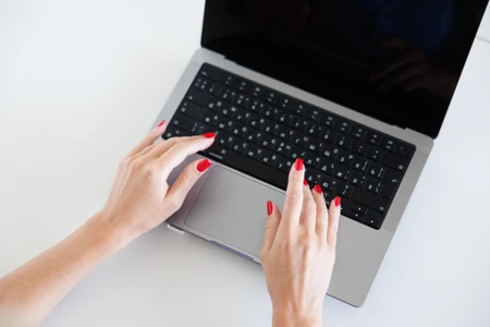 Hands Typing on Laptop