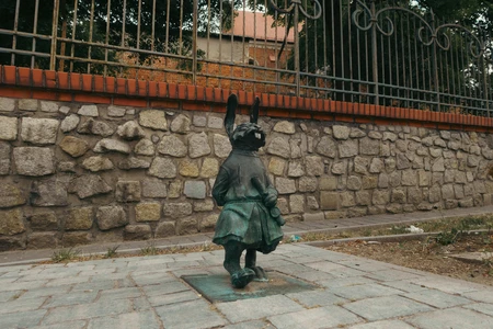 Statue Against Stone Wall