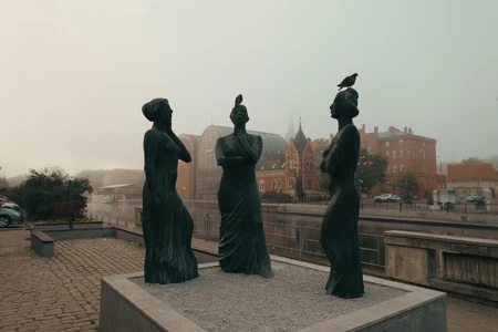 Statue Trio in Urban Setting