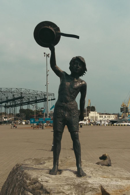 Seaside Statue Under Cloudy Skies