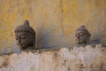Ancient Stone Busts on Weathered Wall