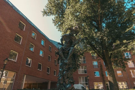 Urban Statue amidst Brick Buildings