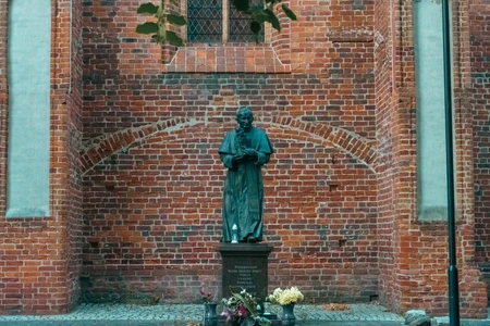 Historic Statue Against Brick Wall