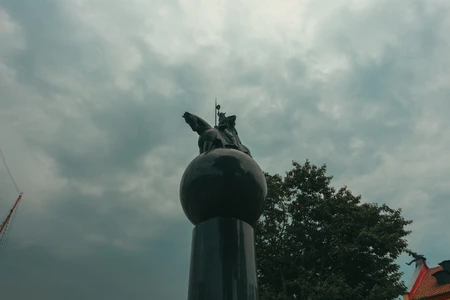 Statue Against Cloudy Sky