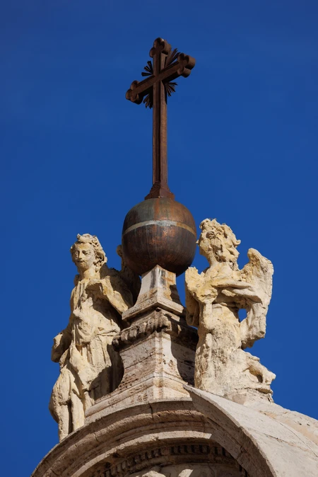 Ornate Cross and Sculptures atop Building