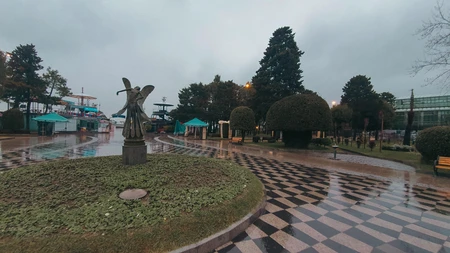 Rainy Park Scene with Monument