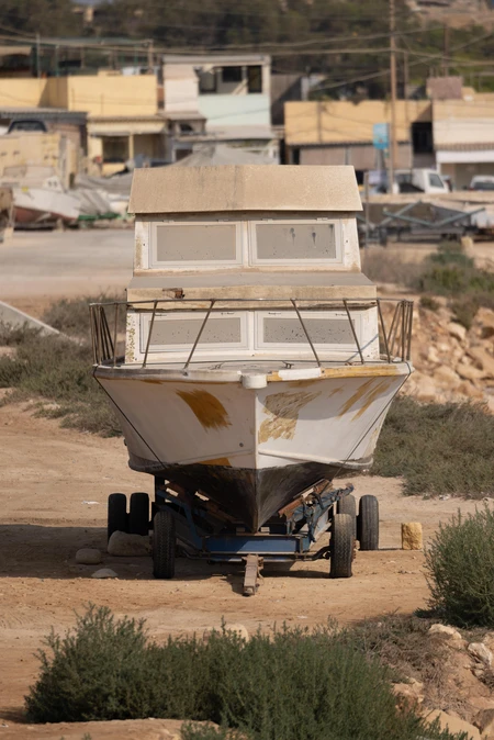 Rustic Boat in Coastal Yard