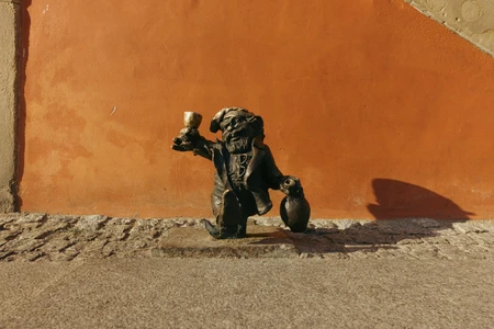Dwarf Statue Against a Vibrant Wall