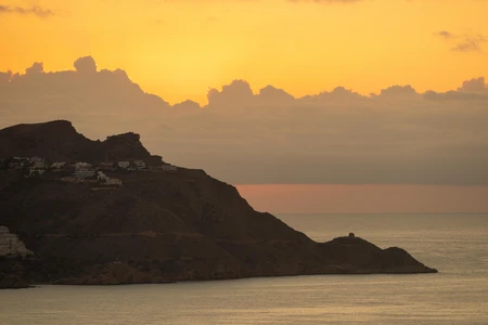 Sunset Over Mountainous Coastline