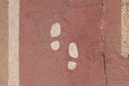 Footprint Path on Red Pavement